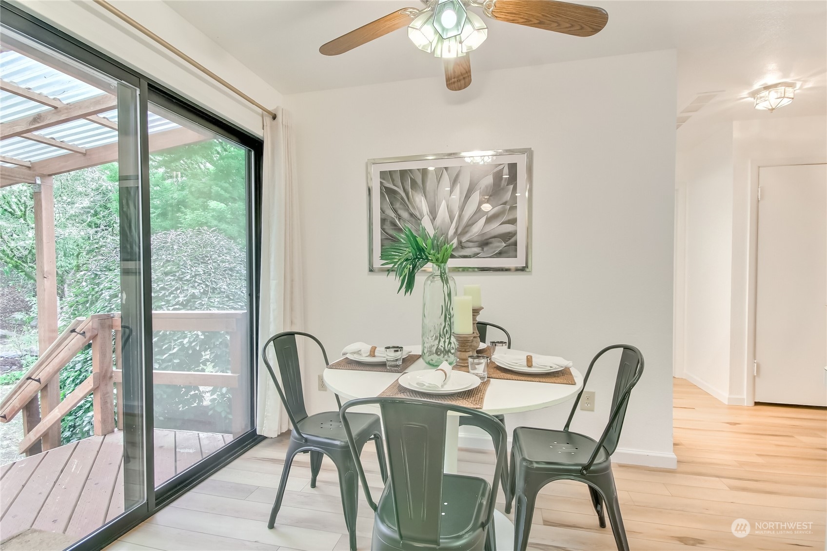 3102 Morrison Road West University Place, WA 98466 - Photo 14 of 36 a dining room with furniture a large window and wooden floor