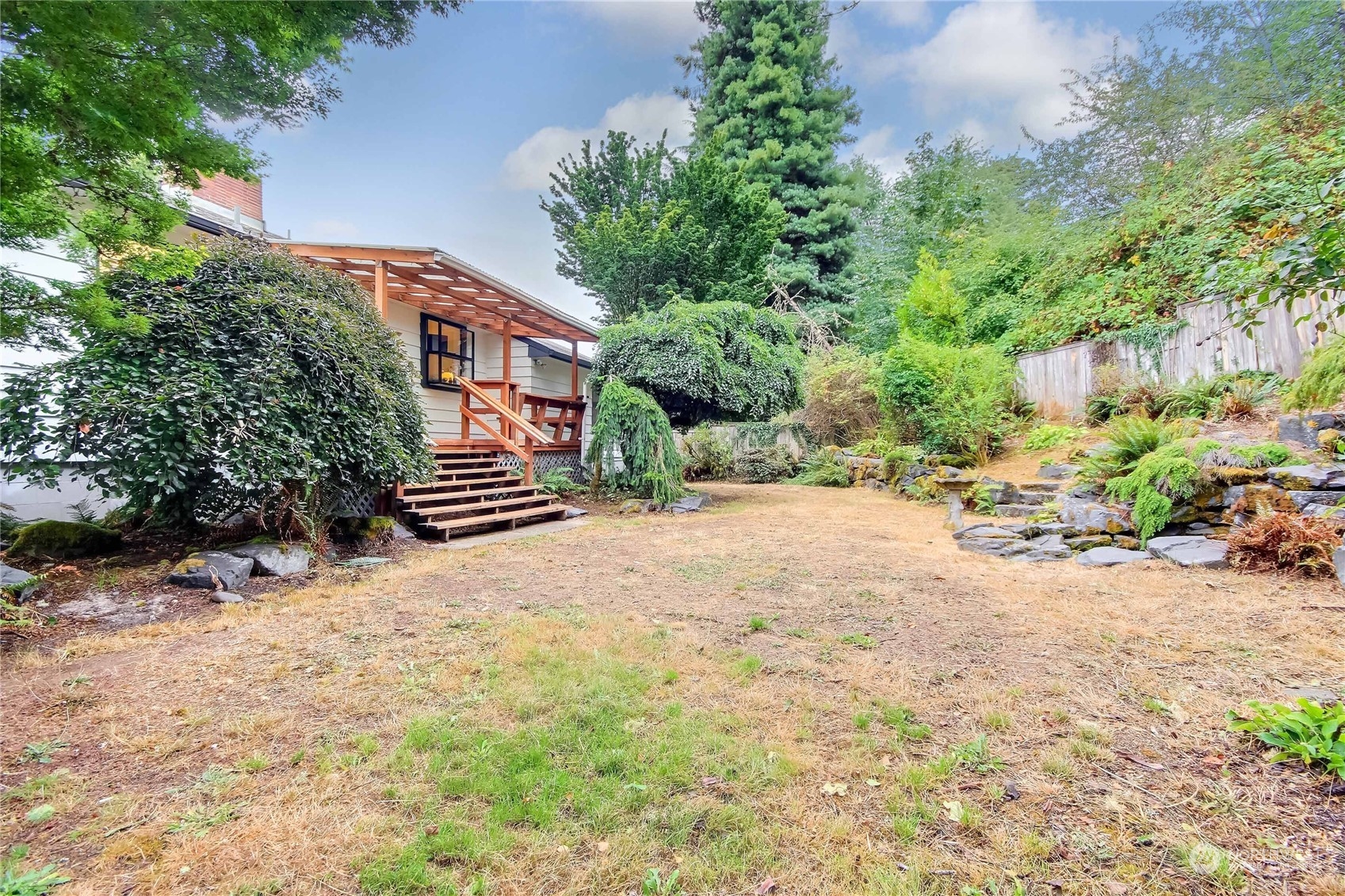 3102 Morrison Road West University Place, WA 98466 - Photo 25 of 36 a backyard of a house with a yard and outdoor seating