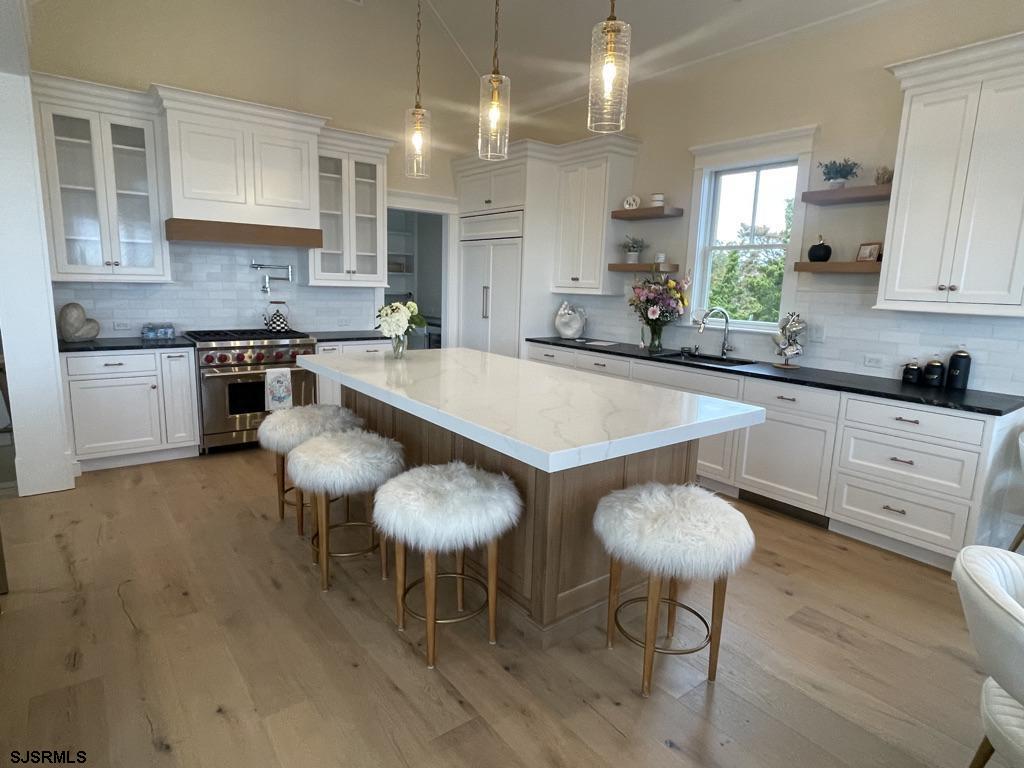 481 7th Street Avalon, NJ 08202 - Photo 11 of 51 a large kitchen with kitchen island a table and chairs in it