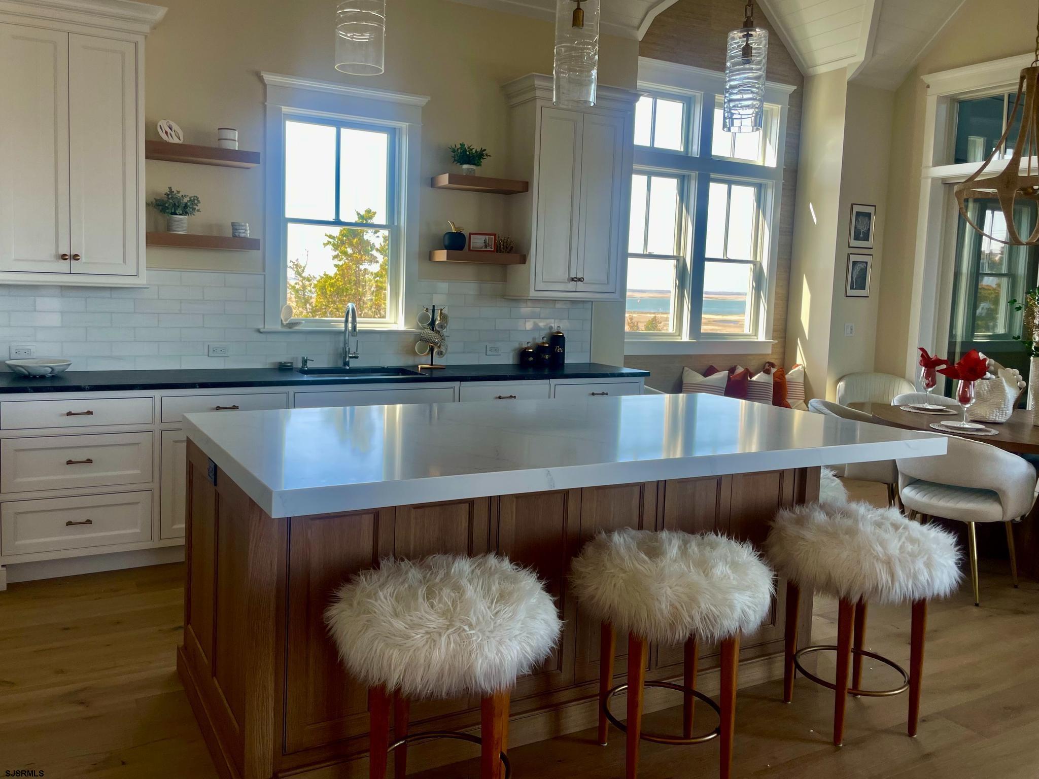 481 7th Street Avalon, NJ 08202 - Photo 12 of 51 a kitchen with a table chairs and cabinets
