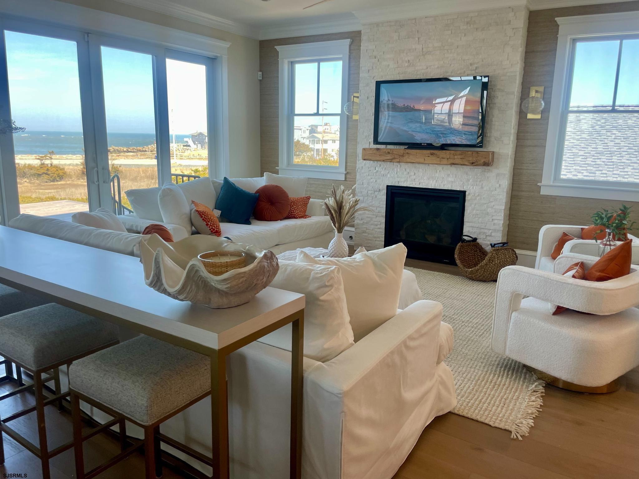 481 7th Street Avalon, NJ 08202 - Photo 15 of 51 a living room with furniture a flat screen tv and a fireplace