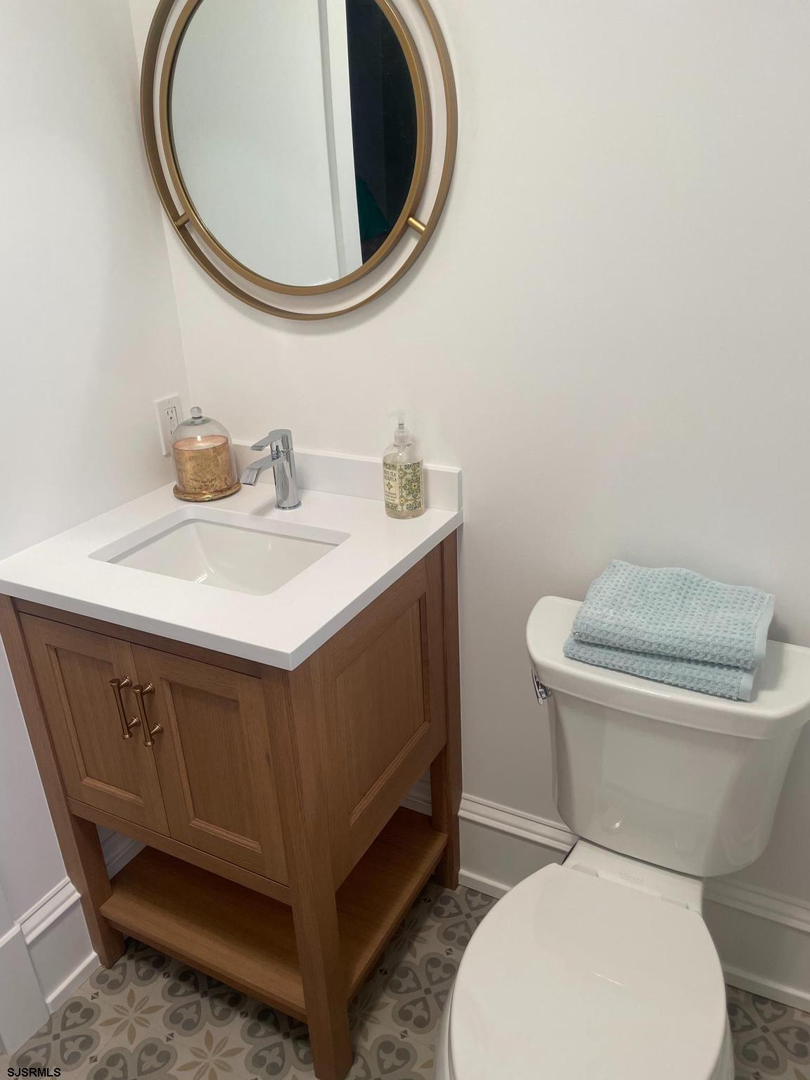 481 7th Street Avalon, NJ 08202 - Photo 17 of 51 a bathroom with a toilet and a mirror