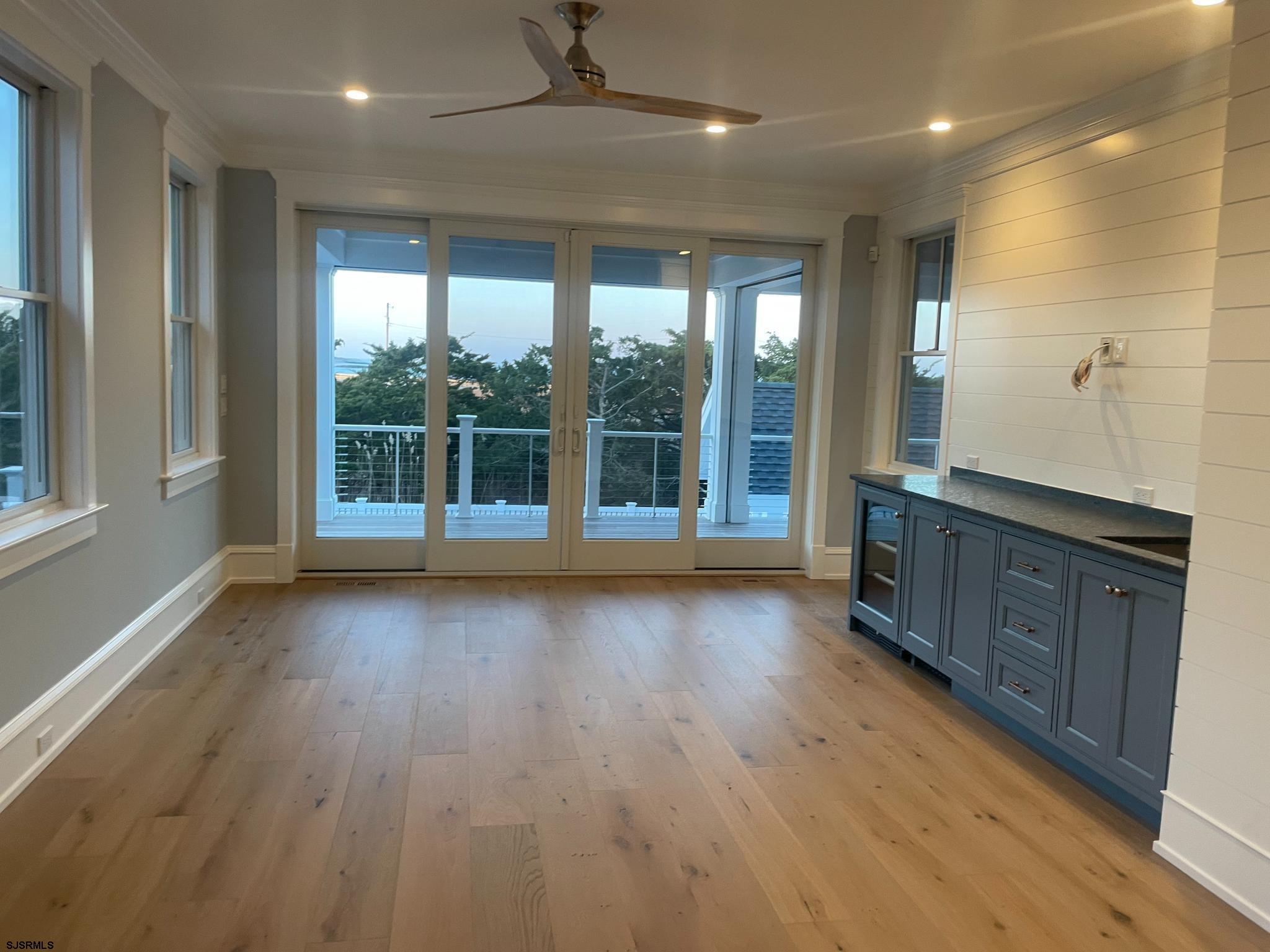 481 7th Street Avalon, NJ 08202 - Photo 18 of 51 an empty room with wooden floor and windows