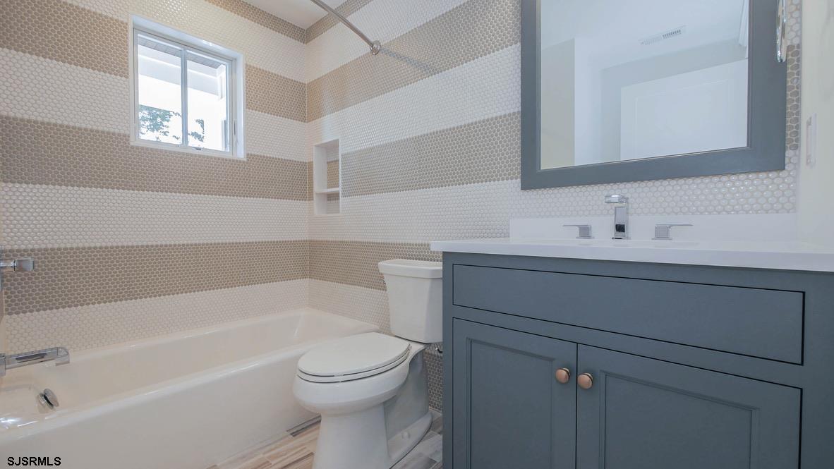 481 7th Street Avalon, NJ 08202 - Photo 22 of 51 a bathroom with a sink toilet vanity and bathtub