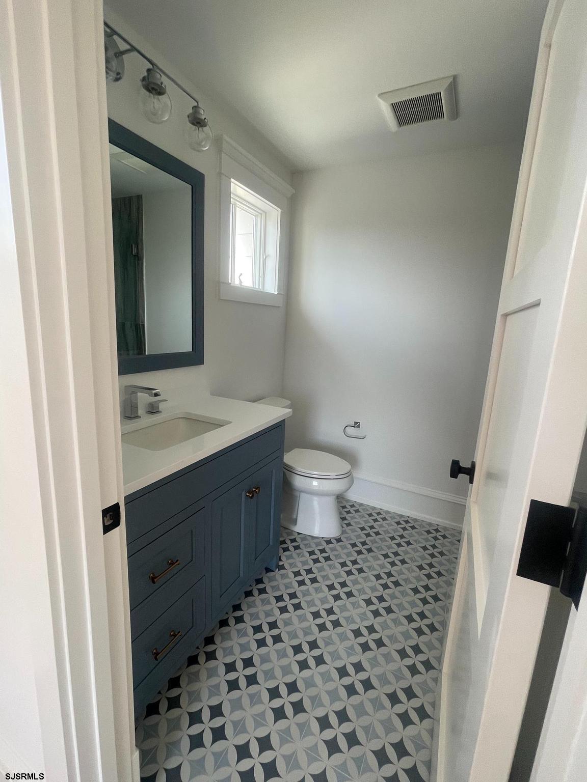 481 7th Street Avalon, NJ 08202 - Photo 30 of 51 a bathroom with a sink a toilet a shower and a mirror
