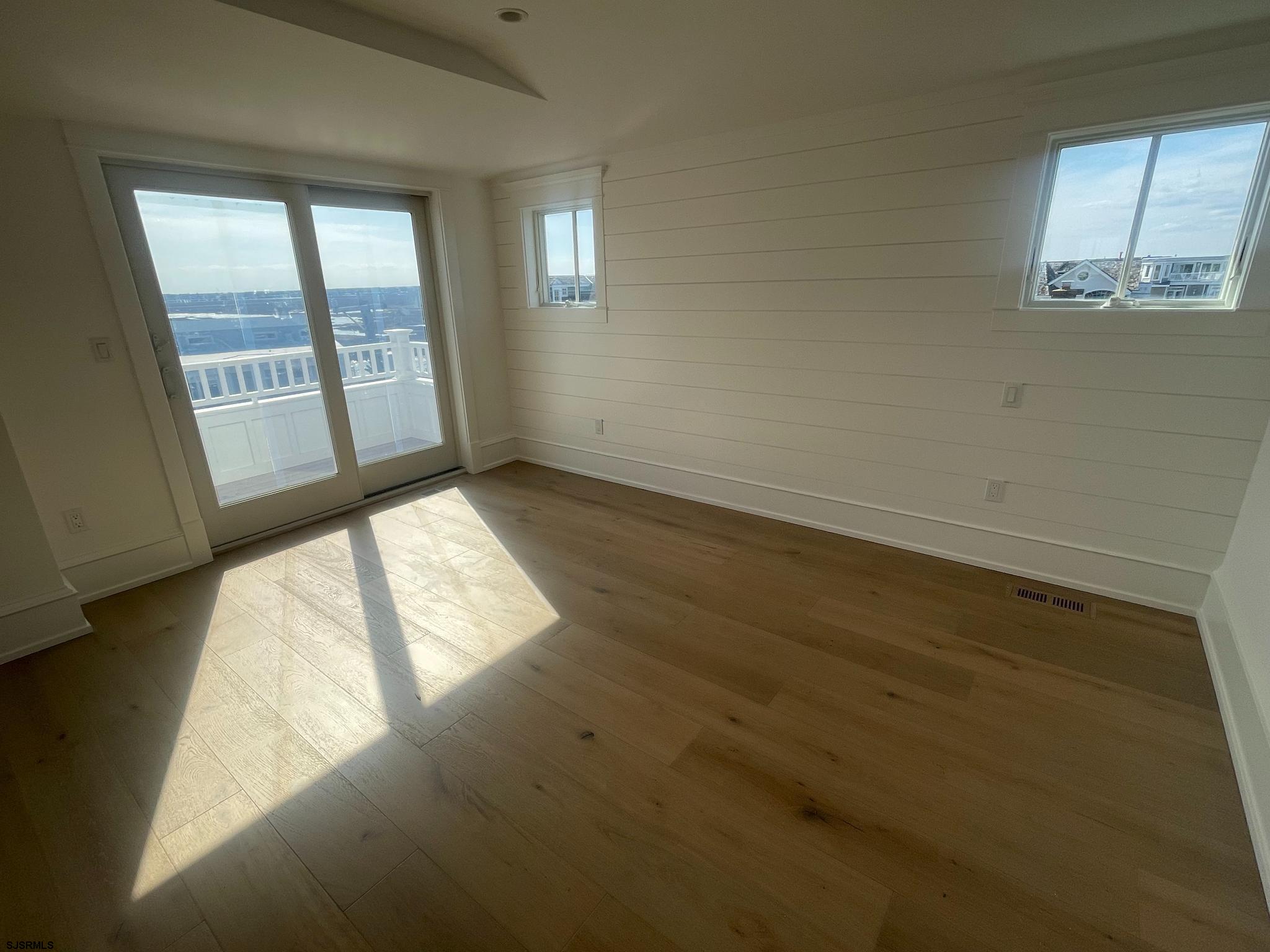 481 7th Street Avalon, NJ 08202 - Photo 36 of 51 an empty room with wooden floor and windows
