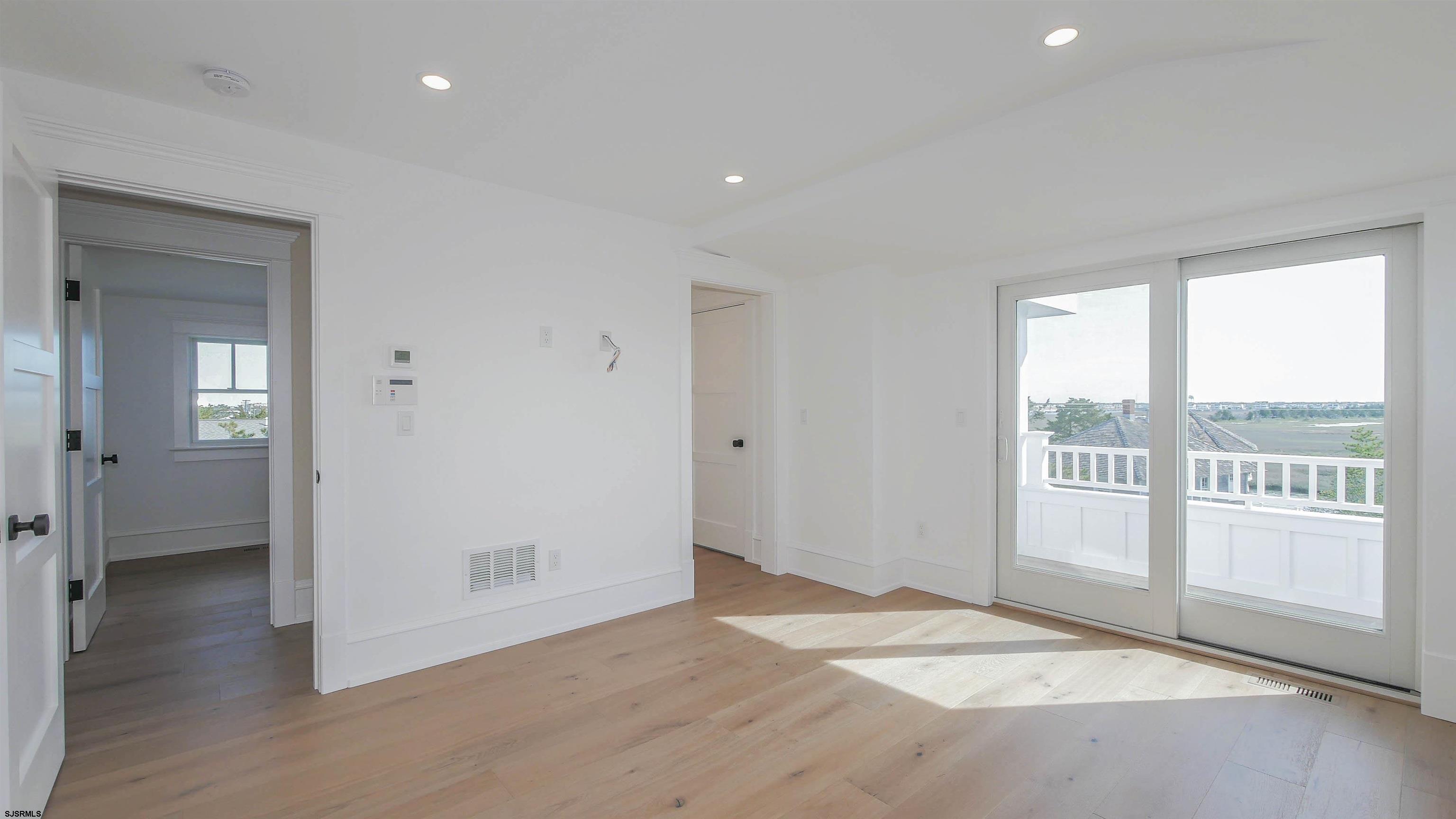 481 7th Street Avalon, NJ 08202 - Photo 37 of 51 an empty room with wooden floor and windows