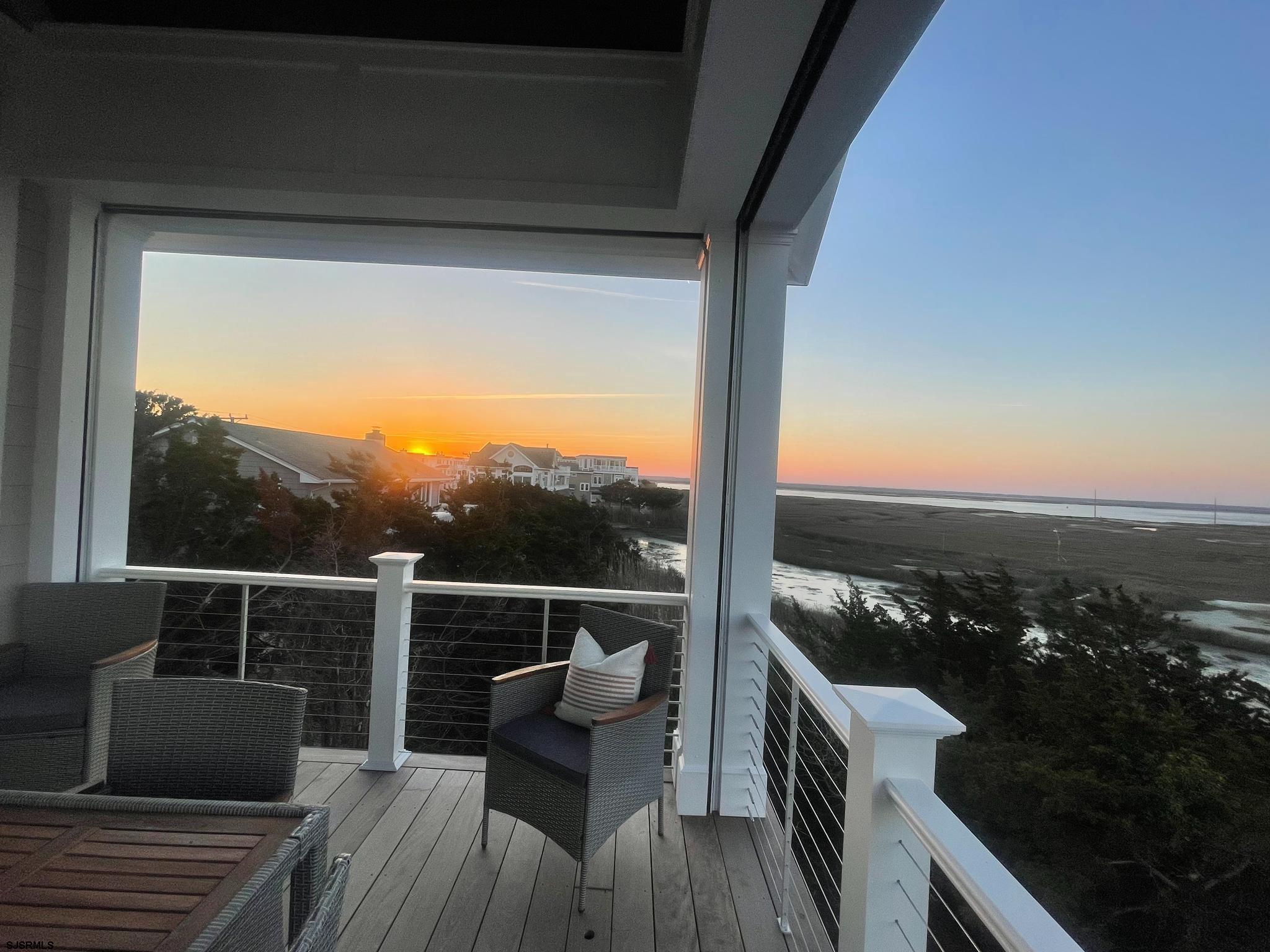 481 7th Street Avalon, NJ 08202 - Photo 5 of 51 a view of a balcony with couches and wooden floor