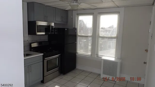 a kitchen with a refrigerator and window
