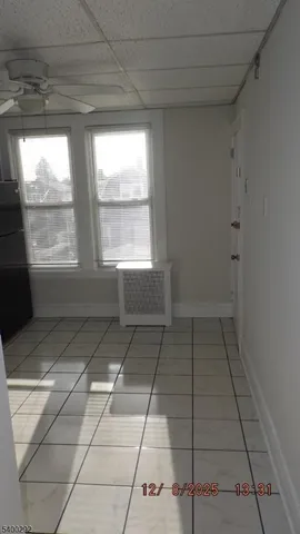 a view of room with wooden floor and windows