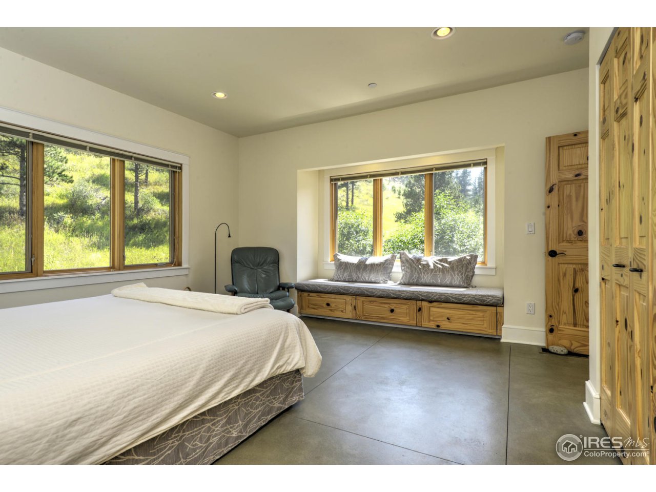 7010 Olde Stage Road Boulder, CO 80302 - Photo 14 of 31 a spacious bedroom with a bed and a large window