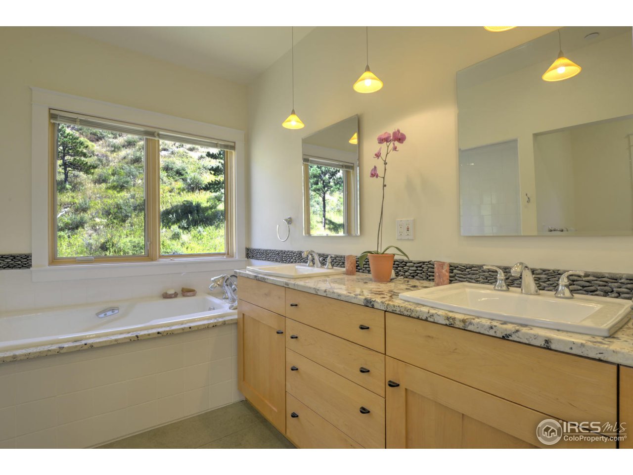 7010 Olde Stage Road Boulder, CO 80302 - Photo 15 of 31 a bathroom with a granite countertop sink mirror and a bathtub