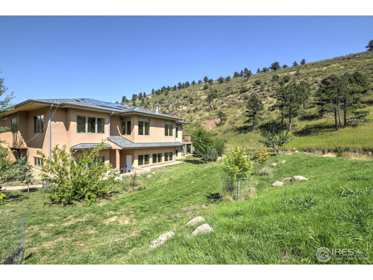 7010 Olde Stage Road Boulder, CO 80302 - Photo 20 of 31 a front view of a house with a garden