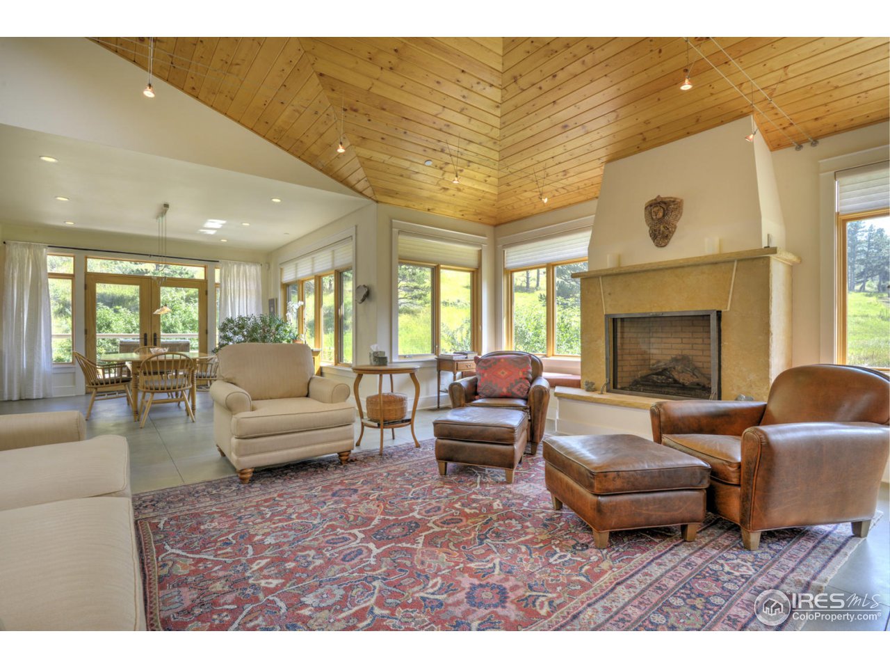 7010 Olde Stage Road Boulder, CO 80302 - Photo 5 of 31 a living room with furniture a fireplace and a flat screen tv