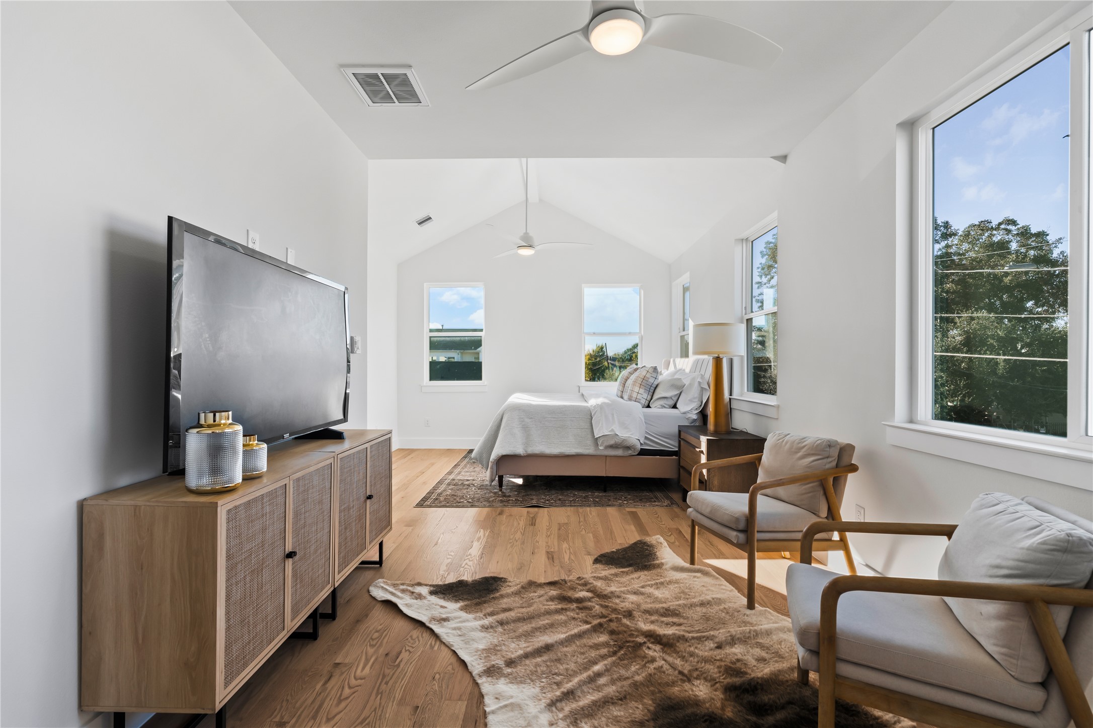 1810 Yates Street Houston, TX 77020 - Photo 18 of 30 The primary suite includes a cozy sitting area that's perfect for unwinding with a book or morning coffee, leading seamlessly into the spa-inspired ensuite bath.