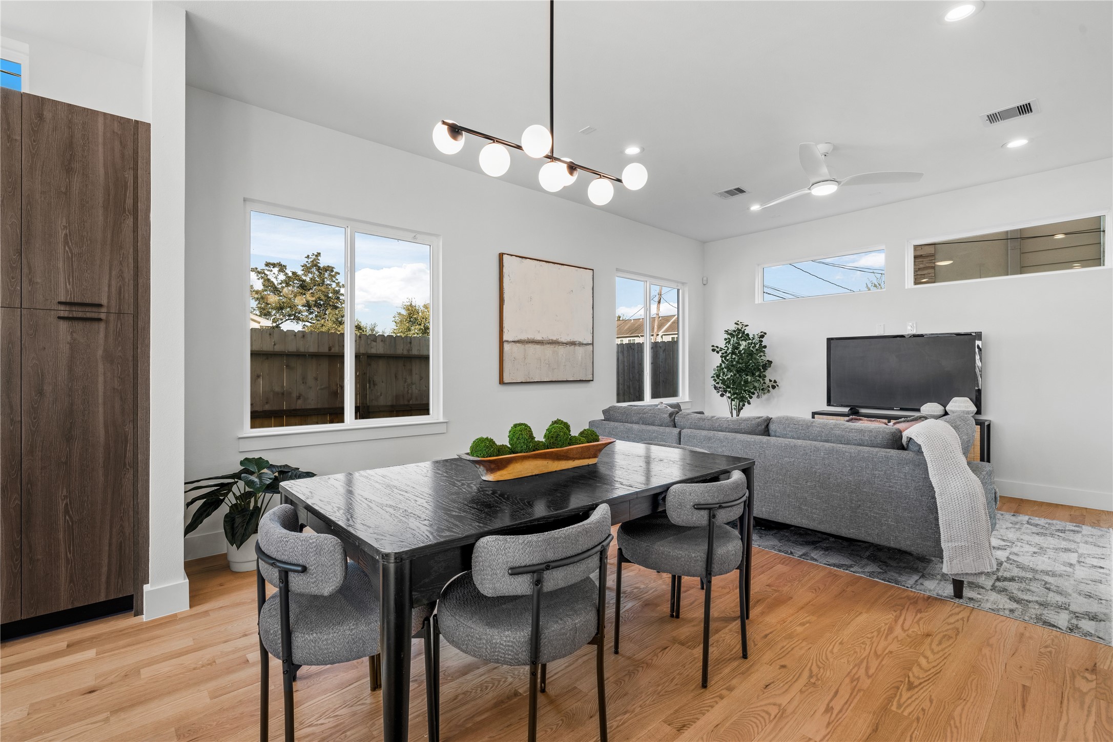 1810 Yates Street Houston, TX 77020 - Photo 8 of 30 Inviting dining area anchored by a chandelier & surrounded by large windows that bring in beautiful natural light, perfect for everyday meals or hosting family and friends.