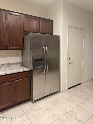 a kitchen with granite countertop cabinets and refrigerator