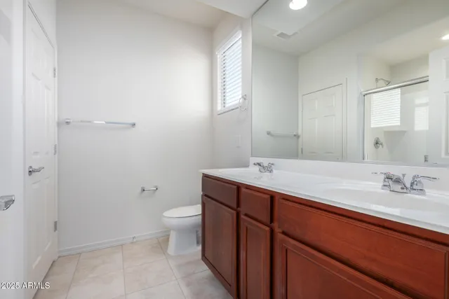 a bathroom with a sink a toilet a shower and a mirror