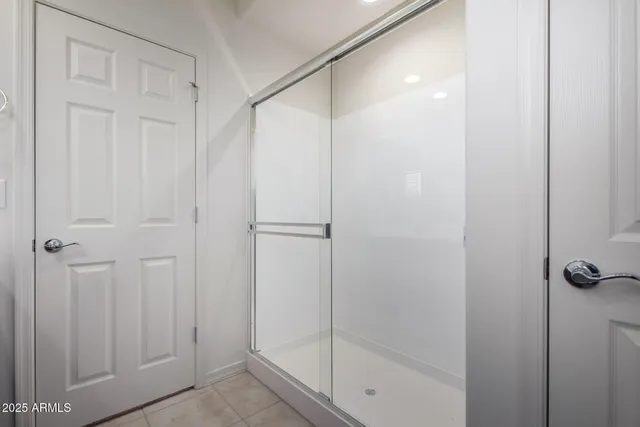 a bathroom with a glass shower door