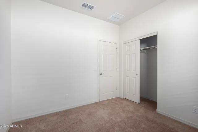 an empty room with closet area
