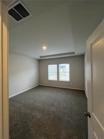 an empty room with a empty space and windows