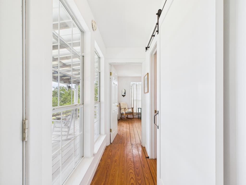 289 Kc 474 Harper, TX 78631 - Photo 14 of 27 a view of a hallway with wooden floor and a bathroom