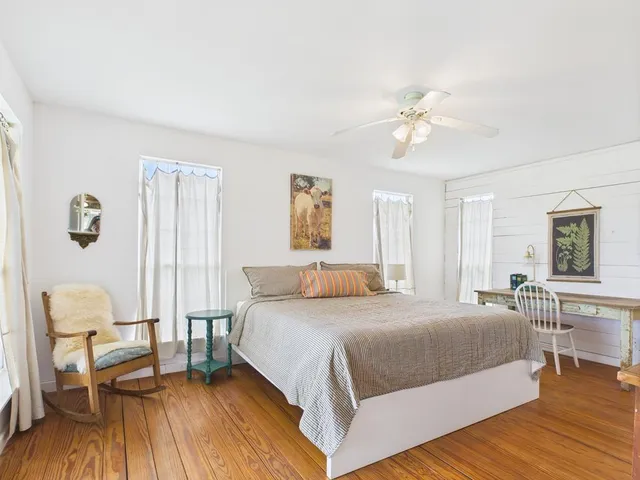 a bedroom with a bed and a chair