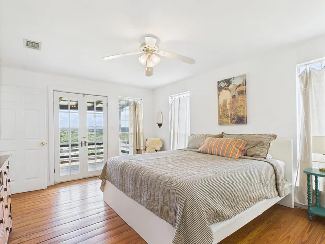 a bedroom with a large bed and a window