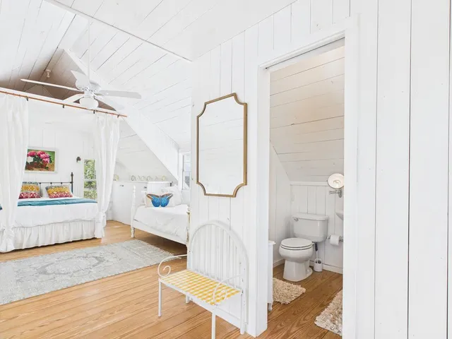 a living room with a toilet and a rug