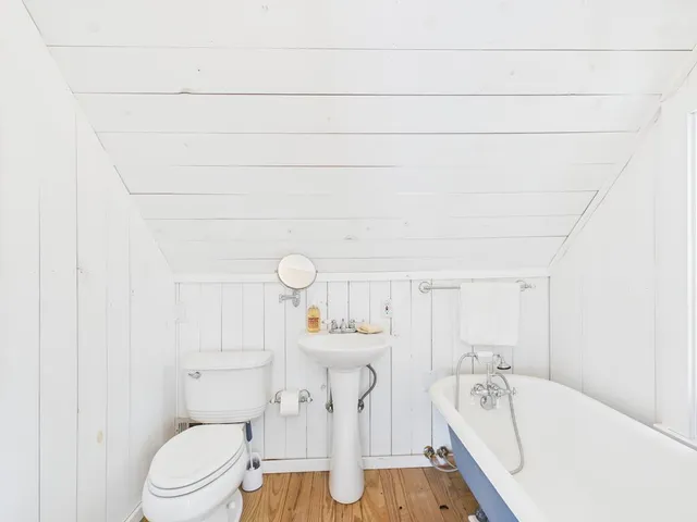 a bathroom with a toilet and a tub
