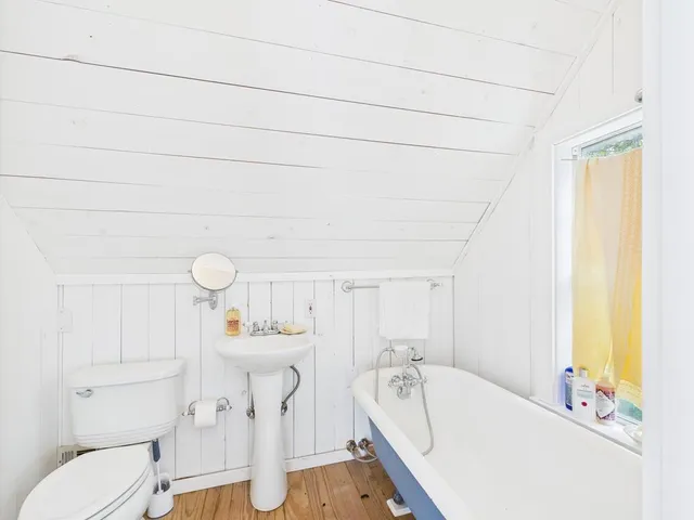 a bathroom with a sink a toilet and tub