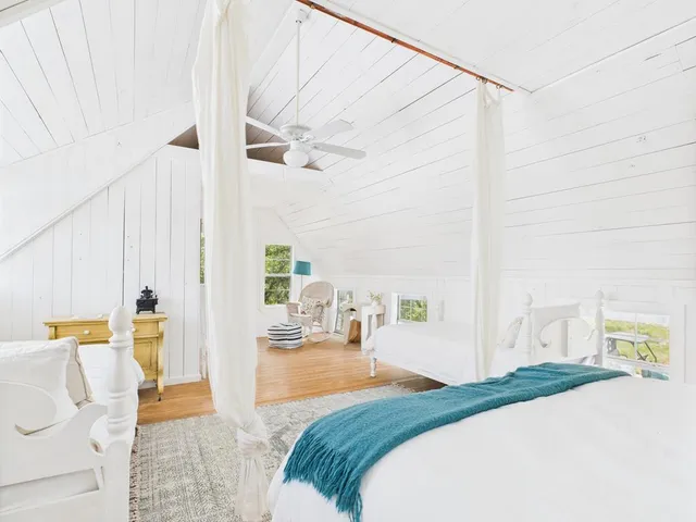 a bed room with a bed and a chair