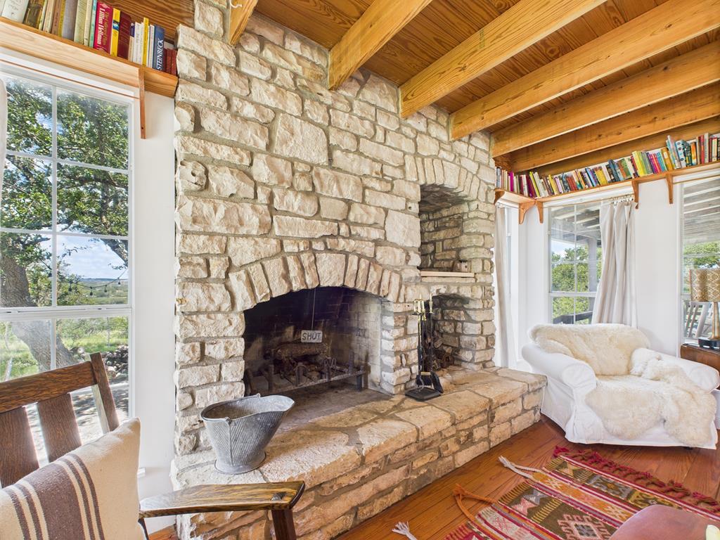 289 Kc 474 Harper, TX 78631 - Photo 5 of 27 a living room with furniture a fireplace and a floor to ceiling window