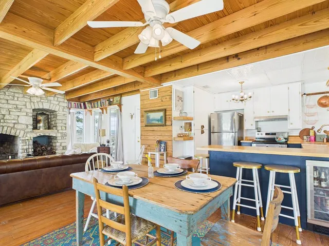 a dining room with furniture and wooden floor
