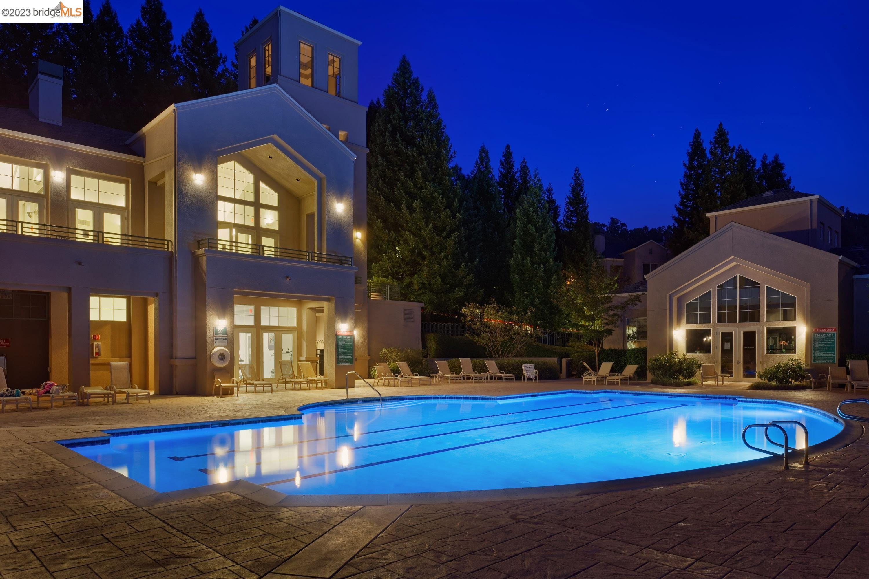 a view of a house with swimming pool yard and outdoor seating