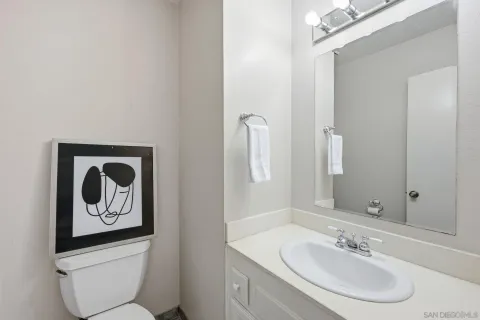 a bathroom with a toilet a sink and mirror