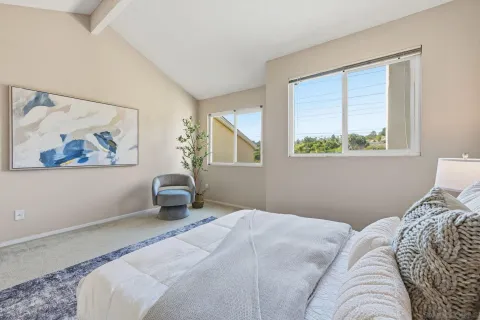 a bedroom with a bed and a painting on the wall