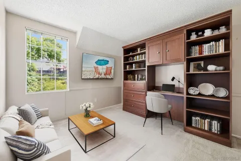 a living room with furniture and a book shelf