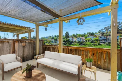 a balcony with furniture and wooden floor