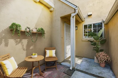 a front view of a house with outdoor seating
