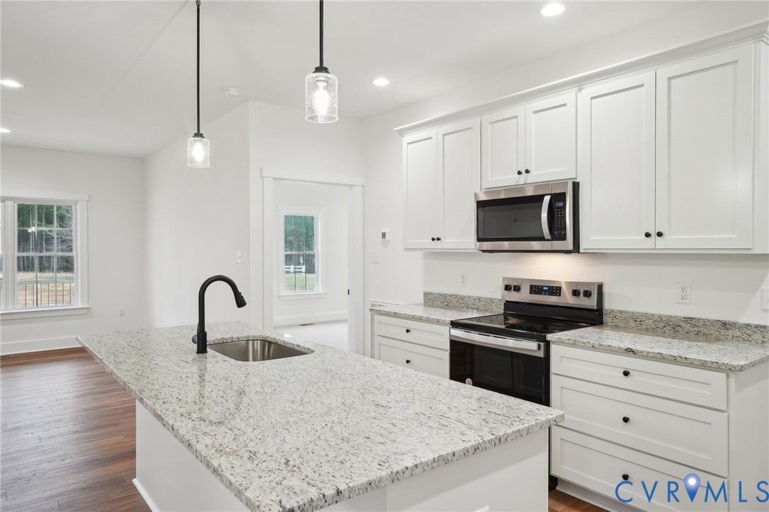 3520 Clintwood Road Midlothian, VA 23112 - Photo 13 of 32 a kitchen with granite countertop a stove a sink a refrigerator and cabinets