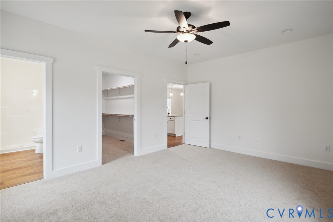 3520 Clintwood Road Midlothian, VA 23112 - Photo 18 of 32 an empty room with a ceiling fan and a view of bathroom
