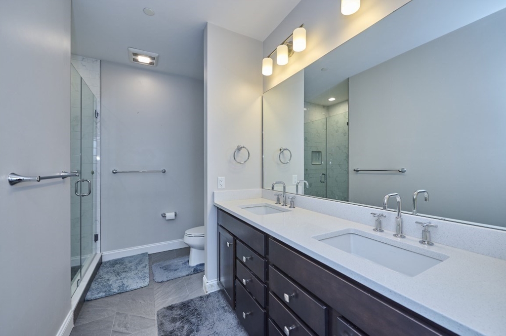 299 Lexington Street, Unit 51 Woburn, MA 01801 - Photo 11 of 37 a bathroom with a double vanity sink mirror double and shower