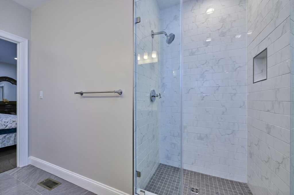 299 Lexington Street, Unit 51 Woburn, MA 01801 - Photo 12 of 37 a bathroom with a shower