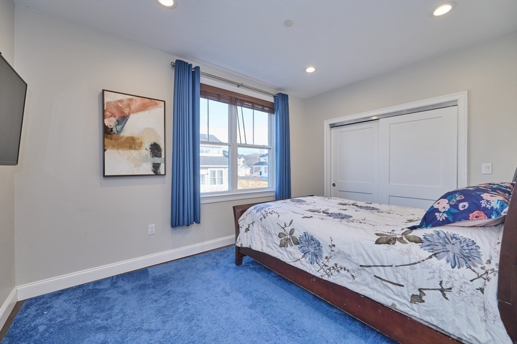 299 Lexington Street, Unit 51 Woburn, MA 01801 - Photo 13 of 37 a bedroom with a bed and a window