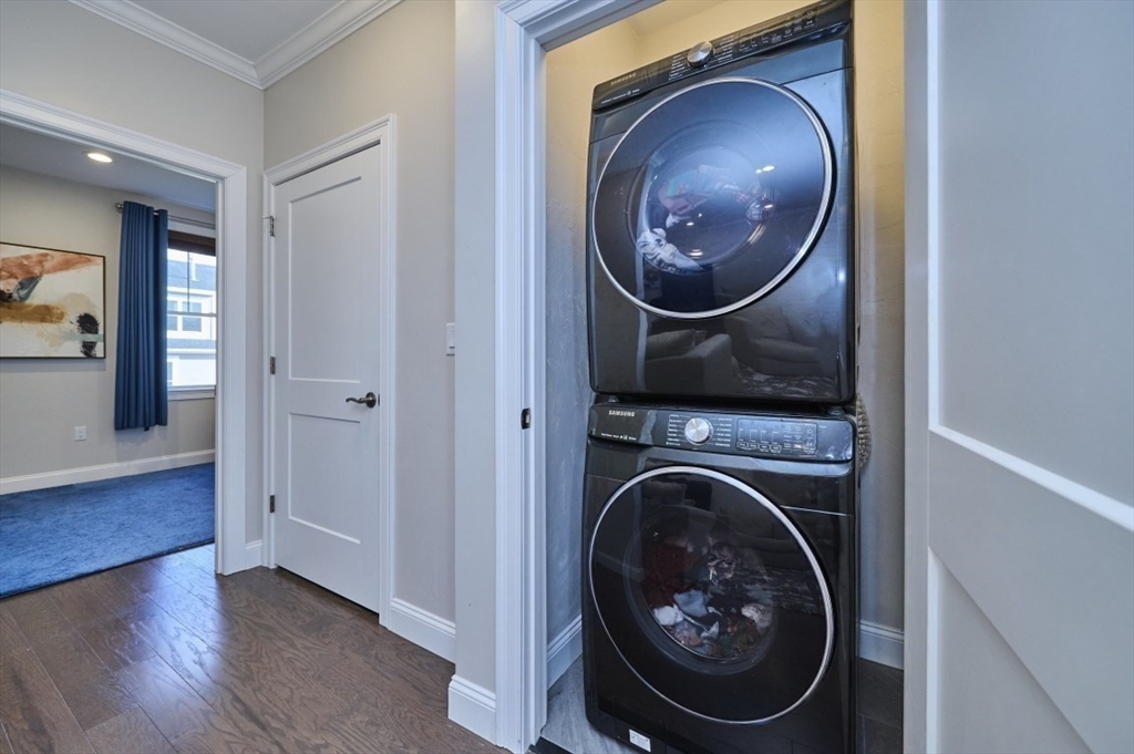 299 Lexington Street, Unit 51 Woburn, MA 01801 - Photo 15 of 37 a view of a hallway with washer and dryer