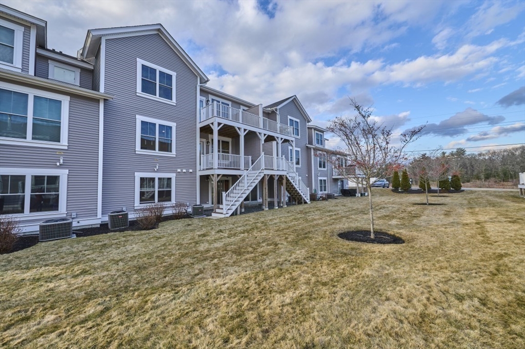 299 Lexington Street, Unit 51 Woburn, MA 01801 - Photo 20 of 37 a view of a yard in front of a building