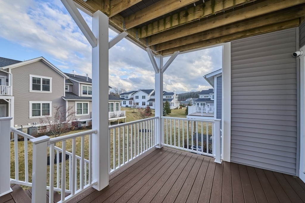 299 Lexington Street, Unit 51 Woburn, MA 01801 - Photo 23 of 37 a view of a house with a wooden deck