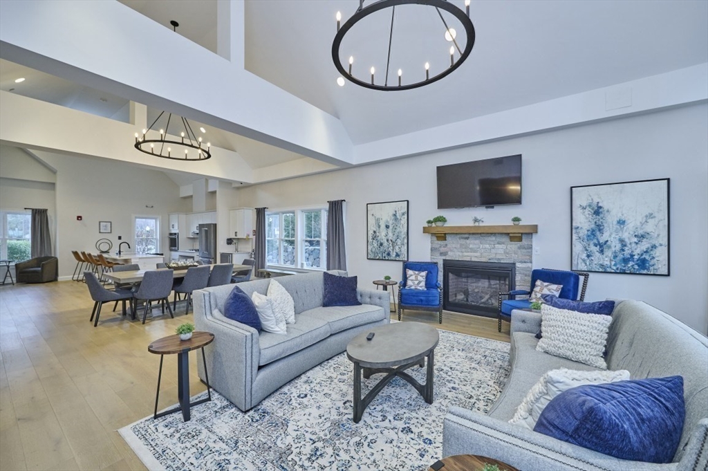 299 Lexington Street, Unit 51 Woburn, MA 01801 - Photo 26 of 37 a living room with furniture a fireplace and a flat screen tv