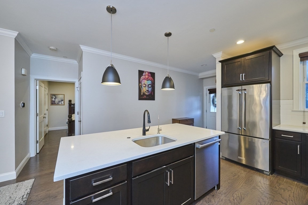 299 Lexington Street, Unit 51 Woburn, MA 01801 - Photo 4 of 37 a kitchen with a sink stainless steel appliances and refrigerator